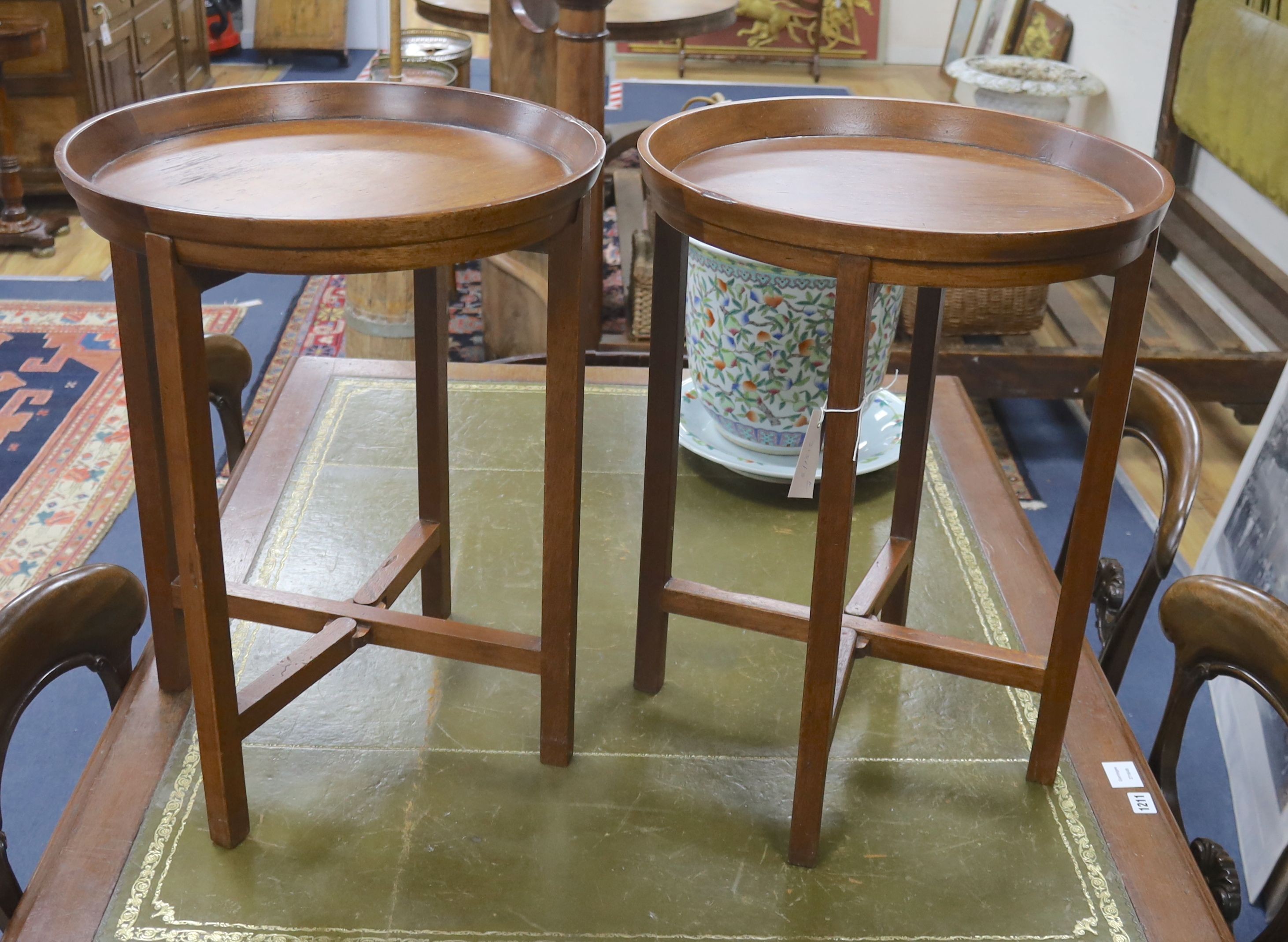 A pair of circular mahogany folding tray top occasional tables, diameter 46cm, height 60cm